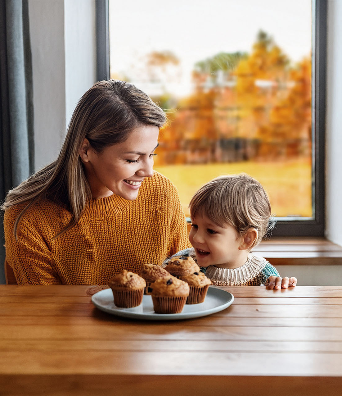 Mother and child enjoying fresh muffins