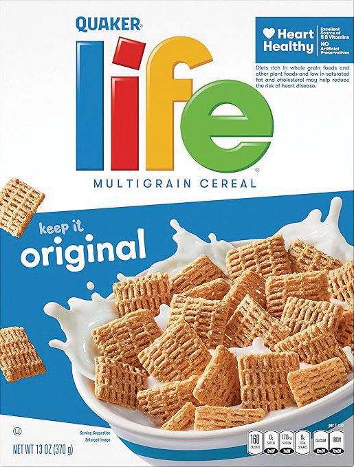 Quaker Life cereal splashing into milk-filled bowl.