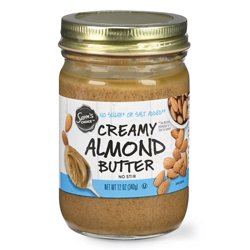 Jar of creamy almond butter with label showing almonds.