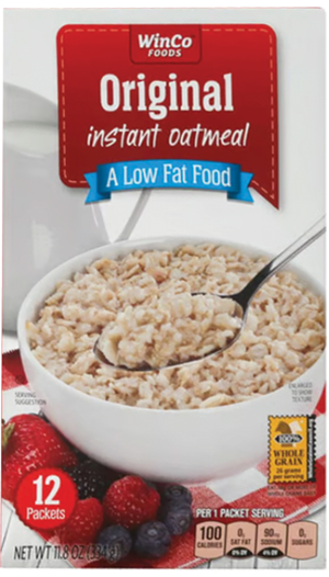 Bowl of oatmeal with spoon on cereal box.