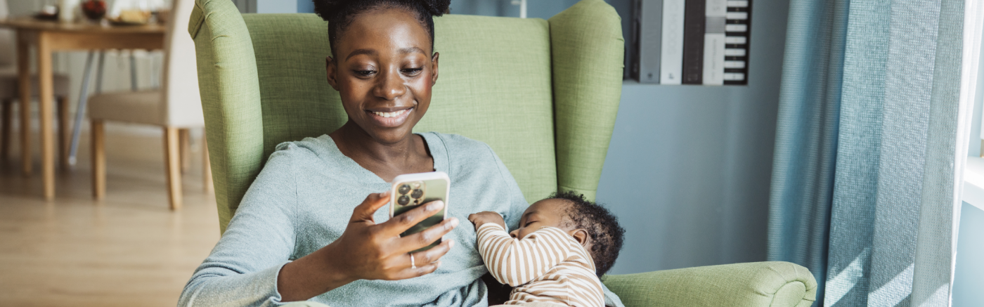 Mom nursing baby using phone